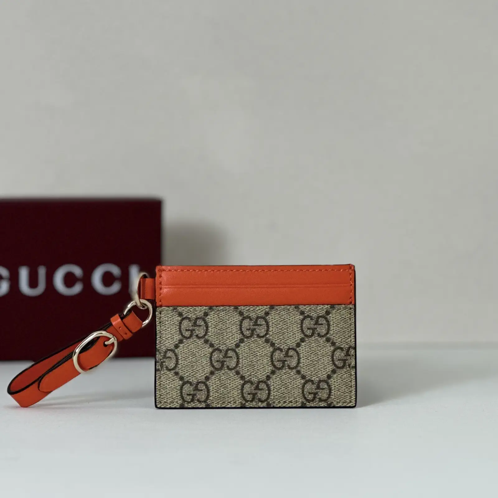 Gucci Monogram Card Holder with Orange Trim and Wrist Strap image 1