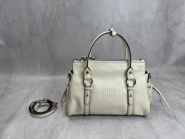 Miu Miu Embossed Logo Top Handle Crossbody Bag image 1