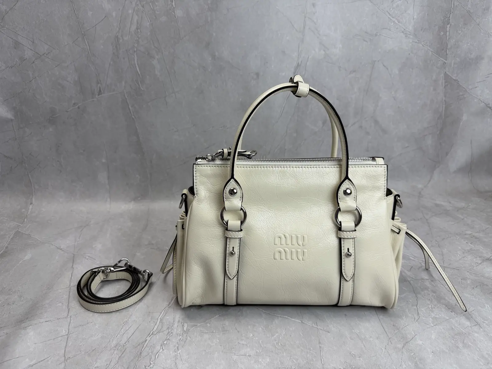 Miu Miu Embossed Logo Top Handle Crossbody Bag image 1