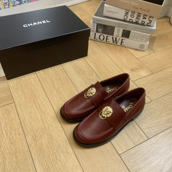 CHANEL Burgundy Leather Loafers with Gold Lion Accent image 1