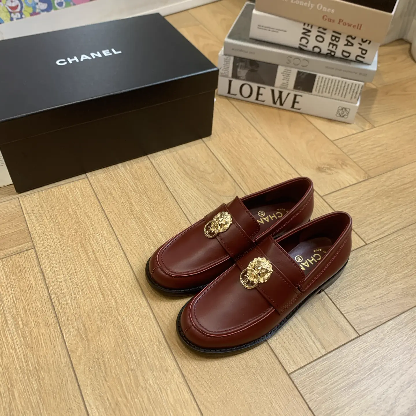 CHANEL Burgundy Leather Loafers with Gold Lion Accent image 1