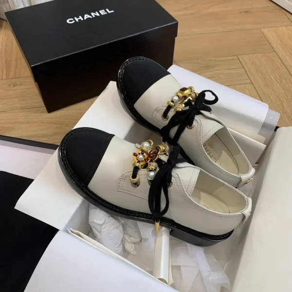 CHANEL Two-Tone Lace-Up Loafers with Decorative Charms image 1