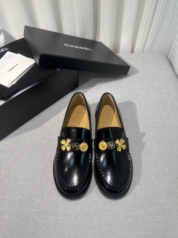 CHANEL Black Patent Leather Loafers with Gold Decorative Charms image 1