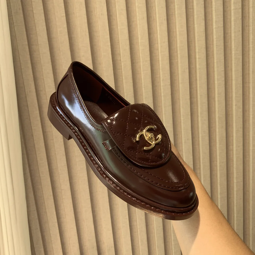 CHANEL Quilted Leather Loafers with Gold-Tone Buckle image 1