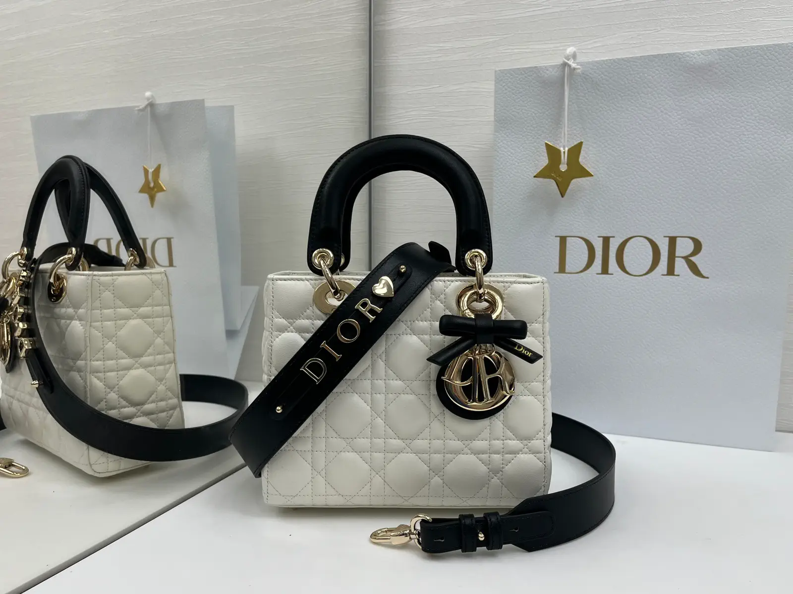 Dior White Quilted Top Handle Bag with Black Strap and Bow Charm image 1